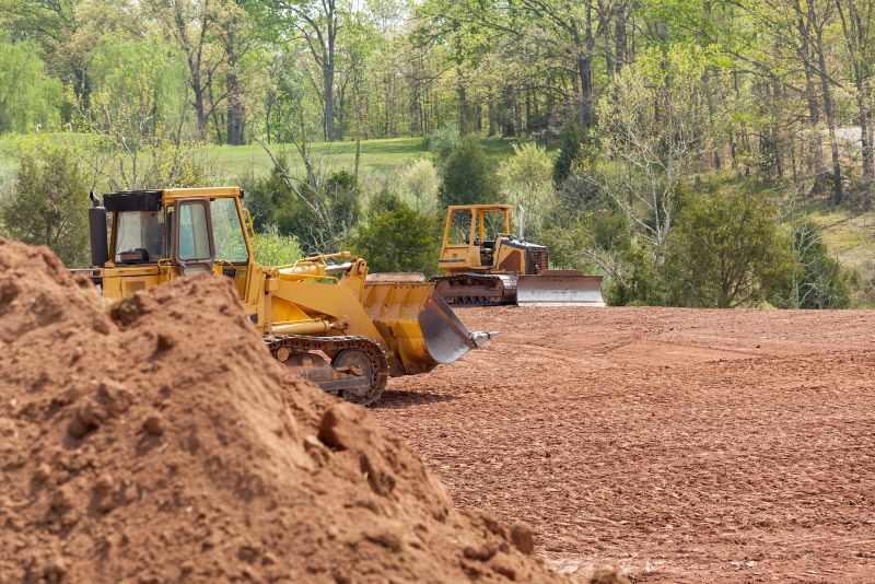 two yellow excavators on site